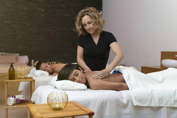 Child having a massage in a spa with his mother